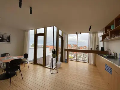 a kitchen and dining room with a table and glass doors at Top Floor New Duplex Stunning View In Trendy St Gilles in Brussels