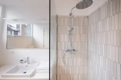 a bathroom with a shower and a sink at Top Floor New Duplex Stunning View In Trendy St Gilles in Brussels