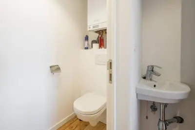 a bathroom with a toilet and a sink at Top Floor New Duplex Stunning View In Trendy St Gilles in Brussels