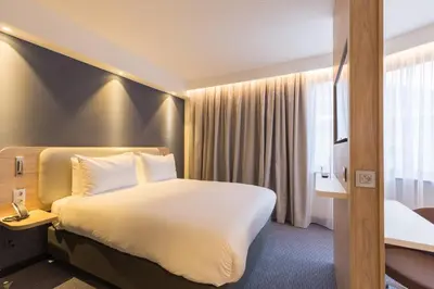 a hotel room with a large bed and a window at Holiday Inn Express Brussels-Grand-Place by IHG in Brussels