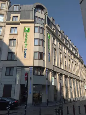 a large building with signs on the front of it at Holiday Inn Express Brussels-Grand-Place by IHG in Brussels