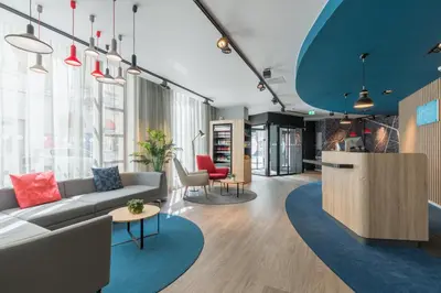 a living room with a couch and a table at Holiday Inn Express Brussels-Grand-Place by IHG in Brussels