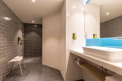 a bathroom with a white sink and a mirror at Holiday Inn Express Brussels-Grand-Place by IHG in Brussels