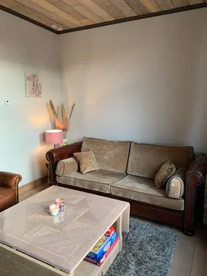a living room with a couch and a coffee table at Vélo 94 in Geel