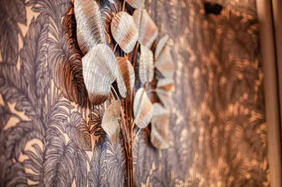 a curtain with leaves on a wall at Luxury Suites Historic Center by Rikas Hotels in Antwerp
