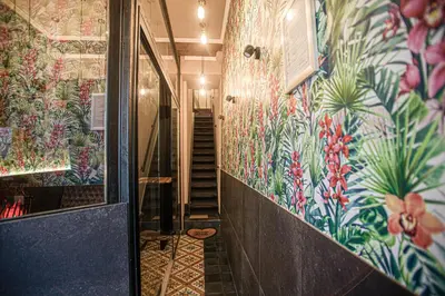 a hallway with colorful walls and stairs in a building at Luxury Suites Historic Center by Rikas Hotels in Antwerp
