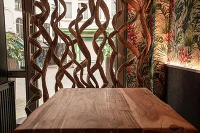 a wooden table sitting in front of a window at Luxury Suites Historic Center by Rikas Hotels in Antwerp