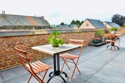a table and chairs sitting on a roof at B&B O Chocolat Cho in Sint-Pieters-Leeuw