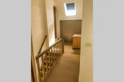an empty hallway with a stairway in a house at Gastenhuis prachtige Historische Vierkant Hoeve in Broechem
