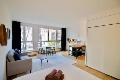 a living room with a couch and a table at New Studio ! in Brussels