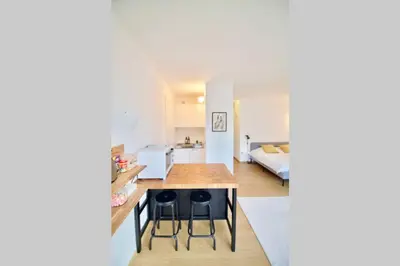 a kitchen with a table and two stools in a room at New Studio ! in Brussels