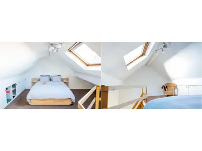 a attic bedroom with a bed and skylights at B&B Place Jourdan in Brussels