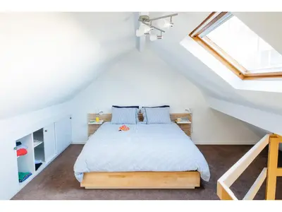 a bedroom with a bed in a attic at B&B Place Jourdan in Brussels