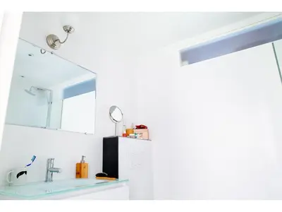 a bathroom with a sink and a mirror at B&B Place Jourdan in Brussels
