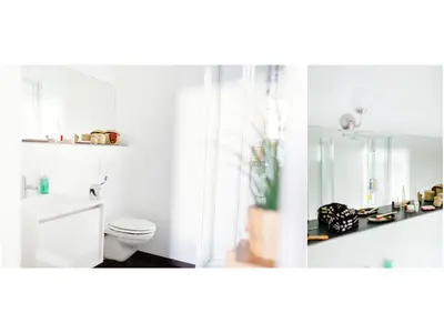 a white bathroom with a toilet and a mirror at B&B Place Jourdan in Brussels