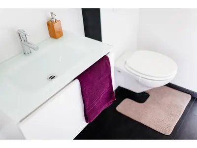 a bathroom with a white sink and a toilet at B&B Place Jourdan in Brussels