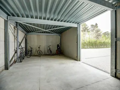a garage with three bikes parked in it at Apartment in Weelde with swimming pool in Weelde