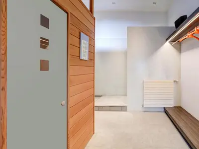 a hallway with a wooden door in a house at Apartment in Weelde with swimming pool in Weelde