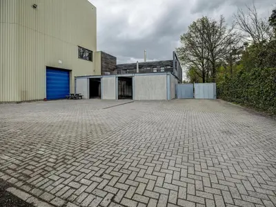 a building with a blue door on the side of it at Apartment in Weelde with swimming pool in Weelde