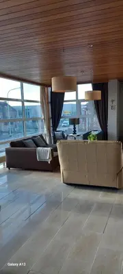 a living room with two couches and a table at Wenceslas Cobergher Penthouse in Boutersem
