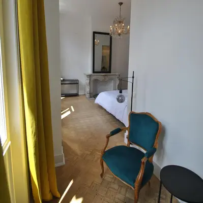 a living room with a chair and a bed at Paulus41 in Antwerp
