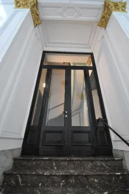 a black door in a room with stairs at Paulus41 in Antwerp