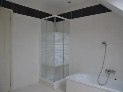a glass shower in a bathroom with a tub at Apartment in Antwerp near Verbeke Museum in Puivelde