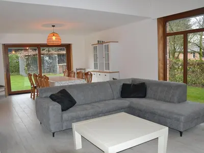 a living room with a couch and a table at Apartment in Antwerp near Verbeke Museum in Puivelde