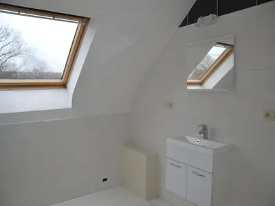 a white bathroom with a sink and a window at Apartment in Antwerp near Verbeke Museum in Puivelde