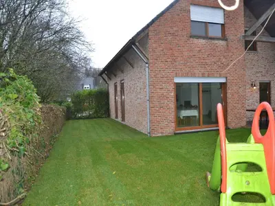 a yard with a house with a yard at Apartment in Antwerp near Verbeke Museum in Puivelde