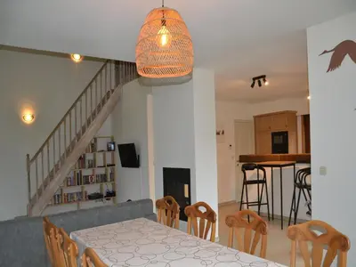 a dining room and kitchen with a table and chairs at Apartment in Antwerp near Verbeke Museum in Puivelde