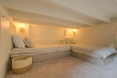 a bedroom with two beds in a room at Logie Marie with hottub in the garden in Lembeke