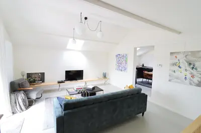 a living room with a couch and a table at Heritage Loft in Londerzeel
