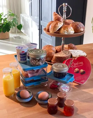 a table with a tray of bread and other food at Heritage Loft in Londerzeel