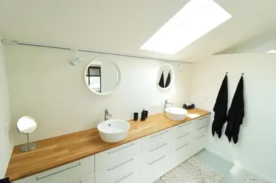 a bathroom with two sinks and a mirror at Heritage Loft in Londerzeel