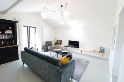 a living room with a couch and a tv at Heritage Loft in Londerzeel