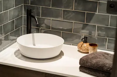 a bathroom sink with a white bowl on a counter at B&B Weselo in Mol