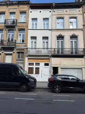 two cars parked in front of a building at Magnifique Studio au 2ème étage, à proximité de la gare du midi! in Brussels
