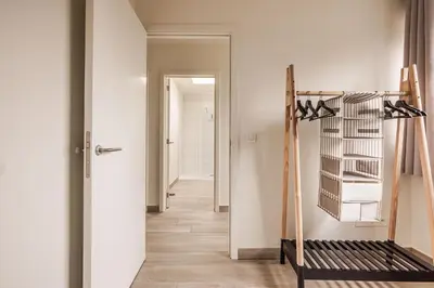 a hallway with a room with white walls at Red Rabbit Tourist and Business Flats with indoor parking - 1 to 5 or 6p - region gnt antwp brux in Zele