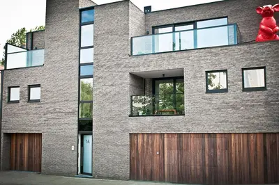 a brick house with a red teddy bear on top at Red Rabbit Tourist and Business Flats with indoor parking - 1 to 5 or 6p - region gnt antwp brux in Zele