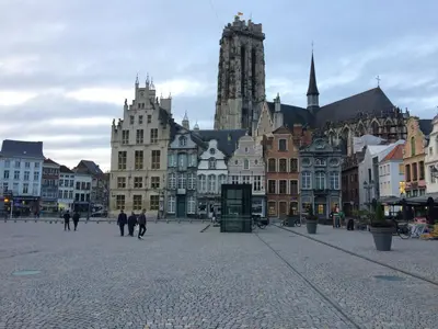 a group of people walking around a city with buildings at Margareta Stay in Mechelen