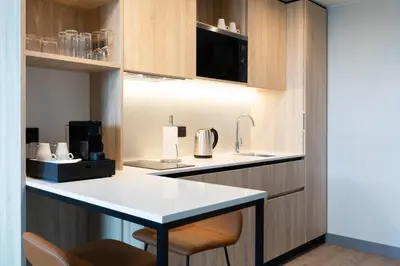 a kitchen with a white counter and a kitchen island at Residence Inn by Marriott Brussels Airport in Diegem