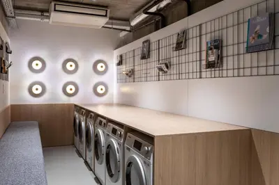 a laundry room with a row of washing machines at Residence Inn by Marriott Brussels Airport in Diegem
