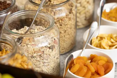 a bunch of jars filled with different types of food at Residence Inn by Marriott Brussels Airport in Diegem