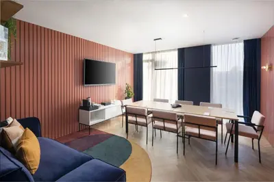 a dining room with a table and chairs and a television at Residence Inn by Marriott Brussels Airport in Diegem