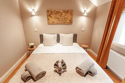 a bedroom with a large bed with two pillows at Luxury Suites Palace by Rikas Hotels in Antwerp