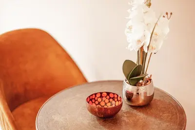 a table with a vase and a bowl with flowers on it at Luxury Suites Palace by Rikas Hotels in Antwerp