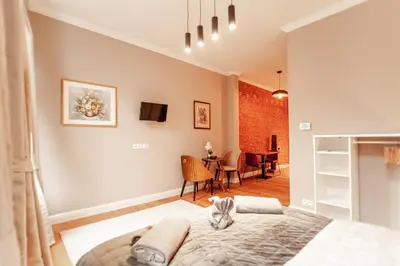 a bedroom with a bed and a dining room at Luxury Suites Palace by Rikas Hotels in Antwerp