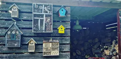 a wall with several wooden houses on it at De linderd in Aalst