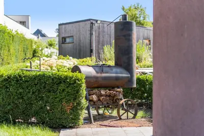 a metal object is sitting next to some bushes at Logie Bloemenlust in Wetteren